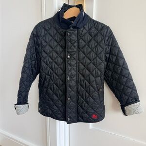 Burberry Black Quilted Jacket with grey lining and navy collar.